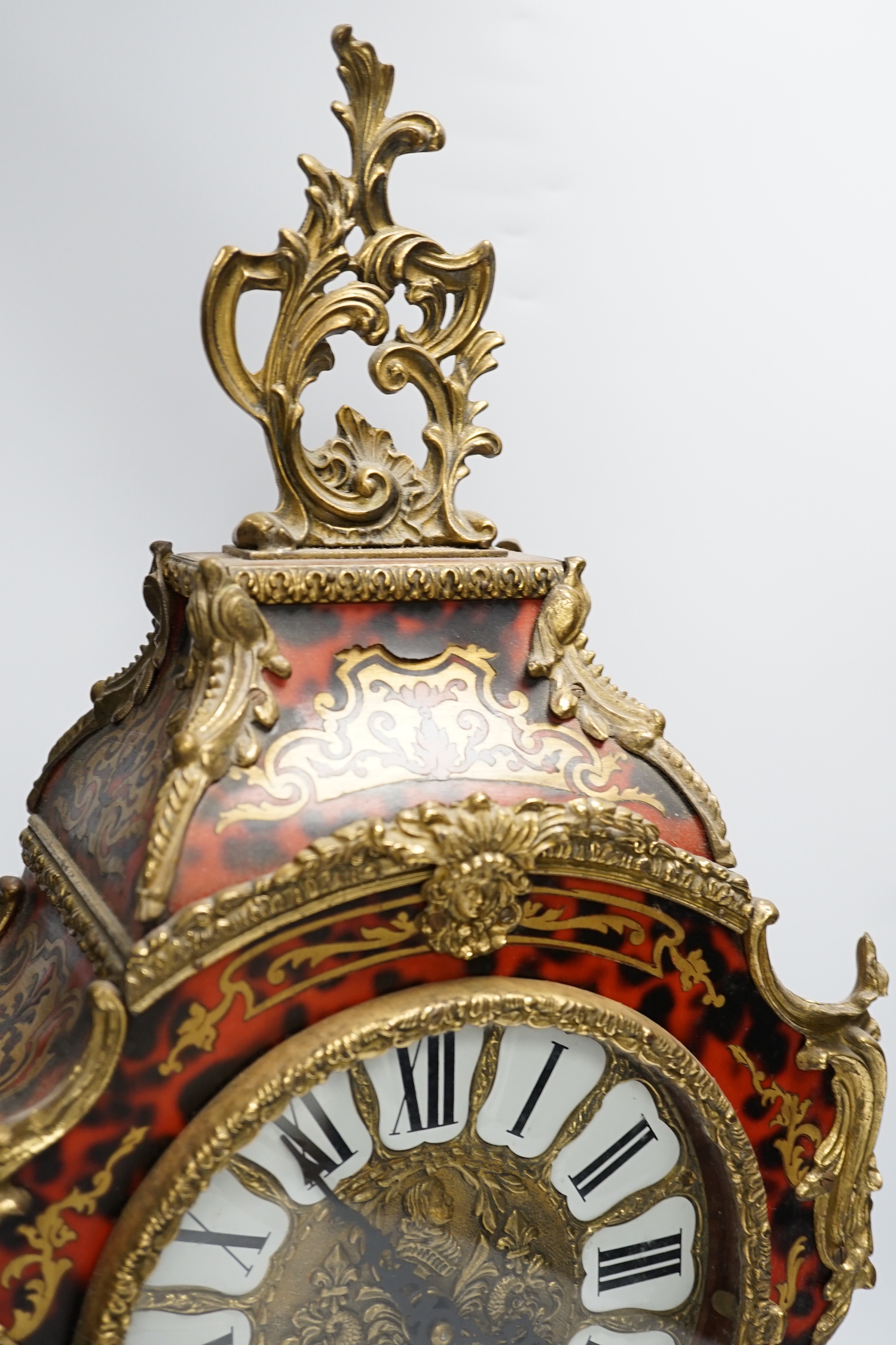 A simulated tortoiseshell Boulle work mantel clock, striking on a bell, 57cm high